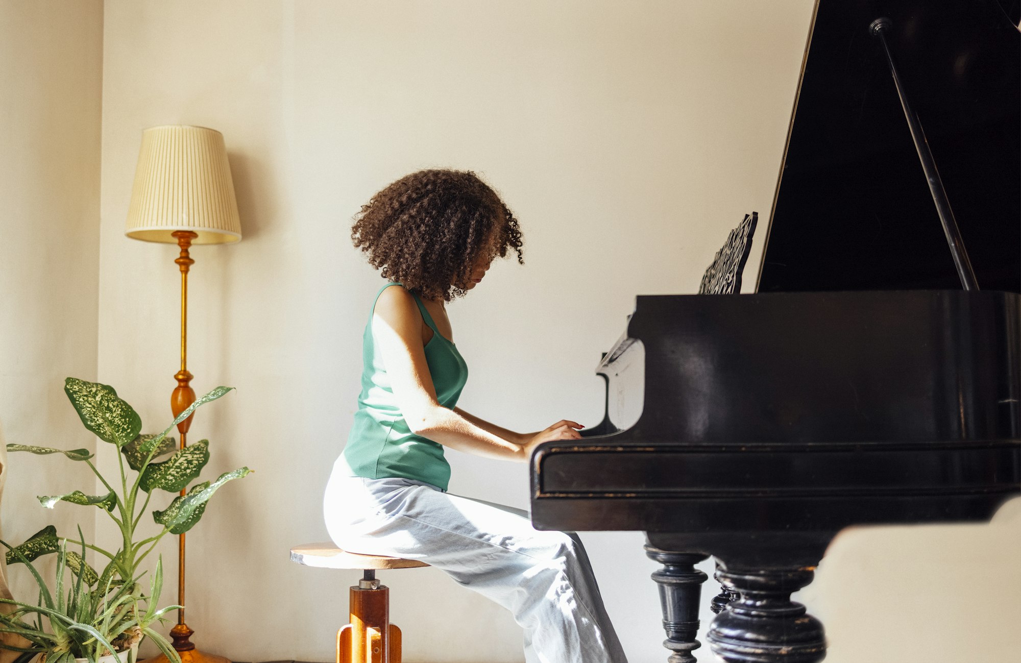 Young black lady playing a piano